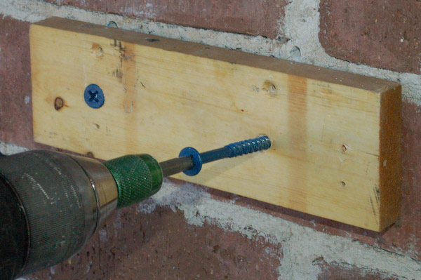 driving concrete screw through wood into concrete