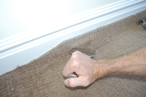 press carpet into tack strip