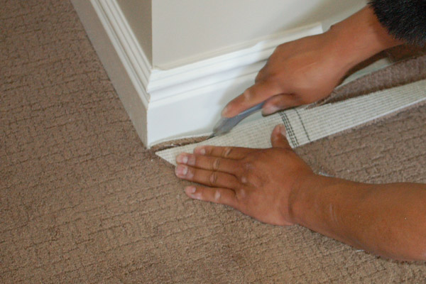 cut carpet at wall with utility knife