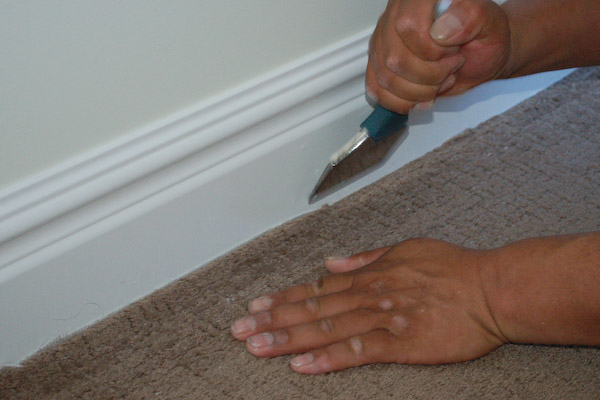 tuck carpet under baseboard