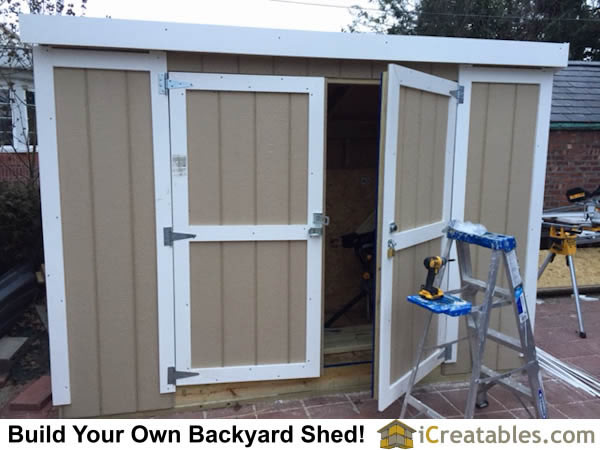 Swinging shed doors and locking hardware installed.