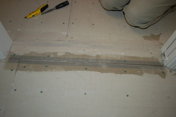 Press fiber mesh tape into cement backer board